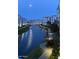 Scenic night view of the community's waterways and building exteriors under the moonlit sky, with illuminated walkways at 2511 W Queen Creek Rd # 179, Chandler, AZ 85248