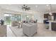 Spacious living area showcasing modern furnishings and smooth transition to the dining and kitchen spaces at 22769 E Orion Way, Queen Creek, AZ 85142