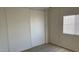 Bedroom with vinyl floors, a large closet, and a window providing natural light at 8730 E Dolega Ave, Mesa, AZ 85208