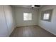 Cozy bedroom with a ceiling fan, mirrored closet doors, and natural light from a window at 8730 E Dolega Ave, Mesa, AZ 85208