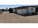 This home features desert landscaping, an AC unit and an attached storage shed for convenience at 8730 E Dolega Ave, Mesa, AZ 85208