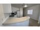 Bright kitchen features white cabinets and appliances, and an extended bar counter at 8730 E Dolega Ave, Mesa, AZ 85208