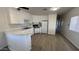 Bright kitchen features white cabinets and appliances, and an extended bar counter at 8730 E Dolega Ave, Mesa, AZ 85208