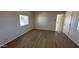 Bright living room featuring light wood flooring and window with blinds at 8730 E Dolega Ave, Mesa, AZ 85208