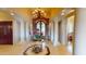 Elegant foyer featuring tile floors, columns, chandelier, and an ornate front door for a grand entrance at 9233 S Krista E Dr, Goodyear, AZ 85338