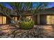 Evening view of courtyard with lounge chairs and tree at 1710 E Staghorn Ln, Carefree, AZ 85377