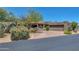 Spanish-style home with a large driveway and desert landscaping at 1710 E Staghorn Ln, Carefree, AZ 85377
