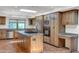Kitchen features island, granite countertops, and stainless steel appliances at 1710 E Staghorn Ln, Carefree, AZ 85377