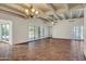 Large living room with tile floors, wood beams, and chandelier at 1710 E Staghorn Ln, Carefree, AZ 85377