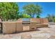 Built-in outdoor kitchen with stone countertops and grill at 1710 E Staghorn Ln, Carefree, AZ 85377