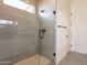 Modern bathroom with a glass shower and grey tile at 17990 W Long Lake Rd, Goodyear, AZ 85338