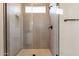 Clean bathroom with a large glass shower and neutral tile at 17990 W Long Lake Rd, Goodyear, AZ 85338