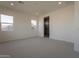 Bright bedroom with carpet flooring and ensuite bathroom access at 17990 W Long Lake Rd, Goodyear, AZ 85338