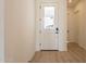 Bright entryway with white door and wood-look flooring at 17990 W Long Lake Rd, Goodyear, AZ 85338