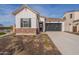 Craftsman style home with brick accents and a two-car garage at 17990 W Long Lake Rd, Goodyear, AZ 85338