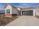 Modern farmhouse exterior with gray garage doors and landscaping at 17990 W Long Lake Rd, Goodyear, AZ 85338