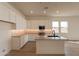 Modern kitchen with white cabinets, island, and herringbone backsplash at 17990 W Long Lake Rd, Goodyear, AZ 85338