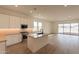 Open concept kitchen with island and view into the living area at 17990 W Long Lake Rd, Goodyear, AZ 85338