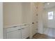 Bright laundry room with built-in cabinets and modern finishes at 17990 W Long Lake Rd, Goodyear, AZ 85338