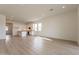 Open concept living room and kitchen with light wood floors at 17990 W Long Lake Rd, Goodyear, AZ 85338