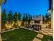 Relaxing backyard with a cozy seating area, outdoor fireplace, and manicured greenery at 3955 E Sierra Vista Dr, Paradise Valley, AZ 85253