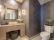 Modern powder room featuring textured wallpaper, a unique stone sink, and stylish lighting at 3955 E Sierra Vista Dr, Paradise Valley, AZ 85253