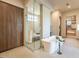 Stylish bathroom featuring a soaking tub, glass shower, and wooden cabinet at 3955 E Sierra Vista Dr, Paradise Valley, AZ 85253