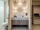 Bright bathroom featuring a vanity with a gray countertop and custom wood cabinets, with decorative lighting and a commode at 3955 E Sierra Vista Dr, Paradise Valley, AZ 85253