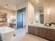 Open bathroom with freestanding tub, vanity, and view of walk-in closet at 3955 E Sierra Vista Dr, Paradise Valley, AZ 85253