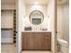 A stylish vanity with a round mirror and a fully equipped walk-in shower give this bathroom a modern look at 3955 E Sierra Vista Dr, Paradise Valley, AZ 85253