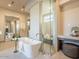 A modern bathroom featuring a large soaking tub and glass-enclosed shower at 3955 E Sierra Vista Dr, Paradise Valley, AZ 85253