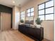 Hallway featuring a console table with decor under a trio of windows, complemented by light wood flooring at 3955 E Sierra Vista Dr, Paradise Valley, AZ 85253