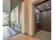 Hallway with striking black and white tiled floors and convenient residential elevator access at 3955 E Sierra Vista Dr, Paradise Valley, AZ 85253
