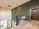 Hallway with light wood floors, an elevator, a bench, and stairs, showcasing a modern design at 3955 E Sierra Vista Dr, Paradise Valley, AZ 85253