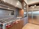 Gourmet kitchen boasts stainless steel appliances, a Wolf cooktop, custom cabinetry, and stone countertops at 3955 E Sierra Vista Dr, Paradise Valley, AZ 85253