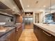 Chef's kitchen features stainless steel appliances, a large island, and views of the dining and living area at 3955 E Sierra Vista Dr, Paradise Valley, AZ 85253