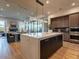 Open-concept kitchen with a large island featuring stone countertops and undermount sink and a view of the dining and living room at 3955 E Sierra Vista Dr, Paradise Valley, AZ 85253