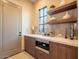 This features a wood-grain cabinet with floating shelves, modern sink, and stainless steel oven at 3955 E Sierra Vista Dr, Paradise Valley, AZ 85253