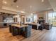 Elegant living room featuring hardwood floors, a stone fireplace, and an adjacent dining area at 3955 E Sierra Vista Dr, Paradise Valley, AZ 85253