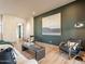 Comfortable living room features a sofa, chairs, wood floors, and a large decorative artwork piece on the wall at 3955 E Sierra Vista Dr, Paradise Valley, AZ 85253