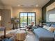 A stylish living room features a gray sofa, modern chairs, and large sliding glass doors at 3955 E Sierra Vista Dr, Paradise Valley, AZ 85253