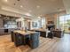 Elegant living room featuring hardwood floors, a stone fireplace, and an adjacent dining area at 3955 E Sierra Vista Dr, Paradise Valley, AZ 85253