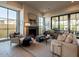 Stylish living room boasting a fireplace, large windows, and hardwood floors at 3955 E Sierra Vista Dr, Paradise Valley, AZ 85253