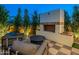 Inviting outdoor seating area featuring a modern fireplace with lush greenery and a cozy ambiance at 3955 E Sierra Vista Dr, Paradise Valley, AZ 85253