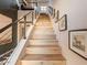 Bright staircase with light wood steps, black metal railings, and framed art decorating the walls at 3955 E Sierra Vista Dr, Paradise Valley, AZ 85253