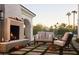 Cozy outdoor fireplace and seating area with mountain views at 4723 E Desert Park Pl, Paradise Valley, AZ 85253