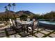 Outdoor dining patio with mountain views, adjacent to a pool and spa at 4723 E Desert Park Pl, Paradise Valley, AZ 85253