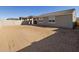 Empty backyard with block wall and view of house at 25218 N 160Th Dr, Surprise, AZ 85387