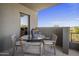 Cozy balcony with a round table, chairs, and scenic views of the neighborhood at 37200 N Cave Creek Rd # 2110, Scottsdale, AZ 85262