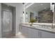 Bathroom featuring double vanity, stone accent wall, standing shower, and modern fixtures at 37200 N Cave Creek Rd # 2110, Scottsdale, AZ 85262
